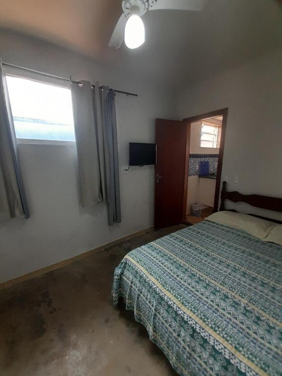 a bedroom with a bed and a window at morada da sagrada familia kit 1 in Guarapari
