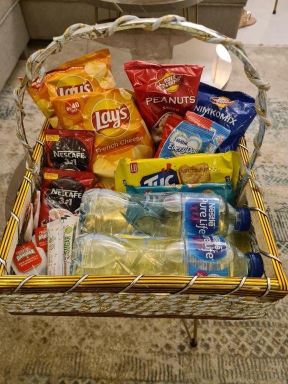 a basket filled with different types of food and drinks at 1 Bed Modern Apartment, Pool, Gym, Cinema in Lahore