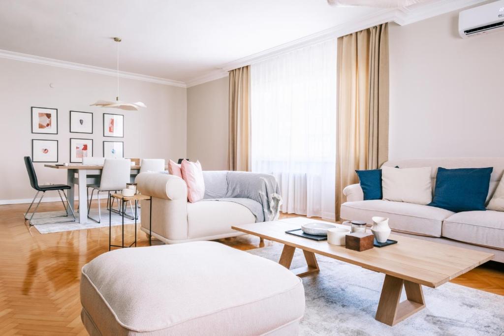 ein Wohnzimmer mit weißen Möbeln und einem Tisch in der Unterkunft Chic in Istanbul