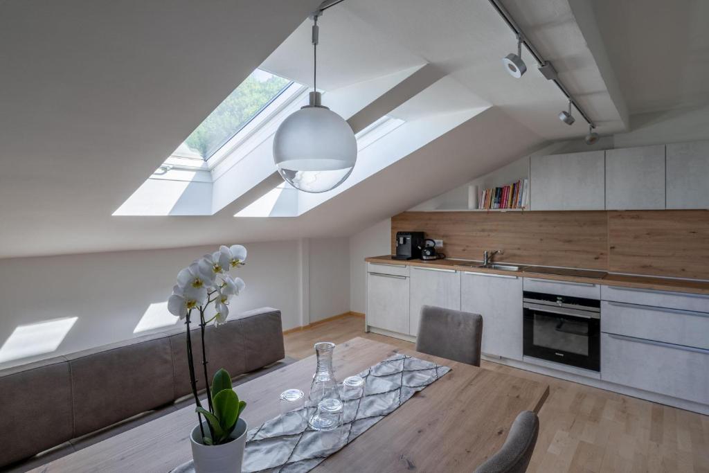 a kitchen with a dining table and a skylight at Haus Walcher in Millstatt