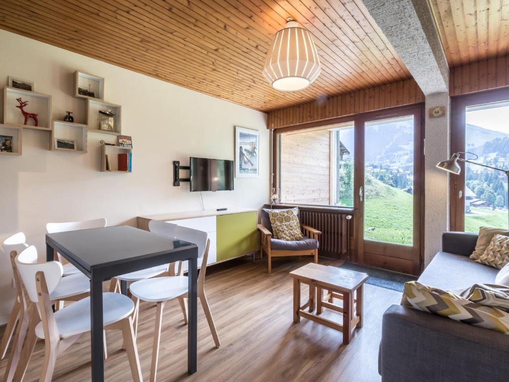a kitchen and living room with a table and chairs at Appartement La Clusaz, 3 pièces, 6 personnes - FR-1-437-59 in La Clusaz