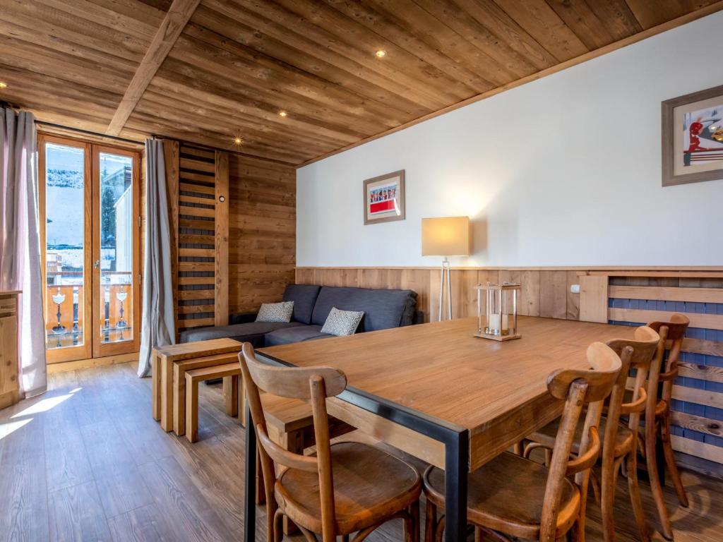 a dining room with a table and chairs and a couch at Appartement La Clusaz, 4 pièces, 8 personnes - FR-1-437-71 in La Clusaz