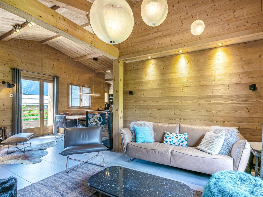 un salon avec un canapé et une table dans l'établissement Chalet 4**** La Clusaz: sur les pistes, 10 pers, terrasse, garage, Wifi, linge inclus - FR-1-437-80, à La Clusaz