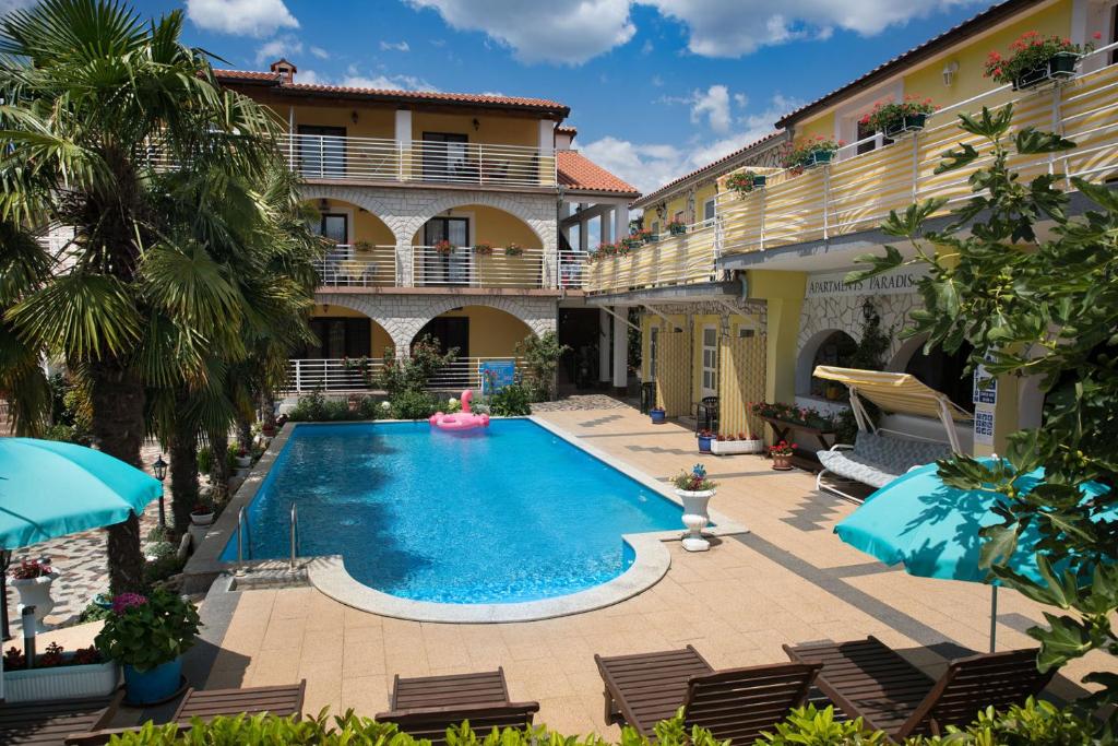 an image of a swimming pool in front of a building at Apartments Paradis in Rovinj