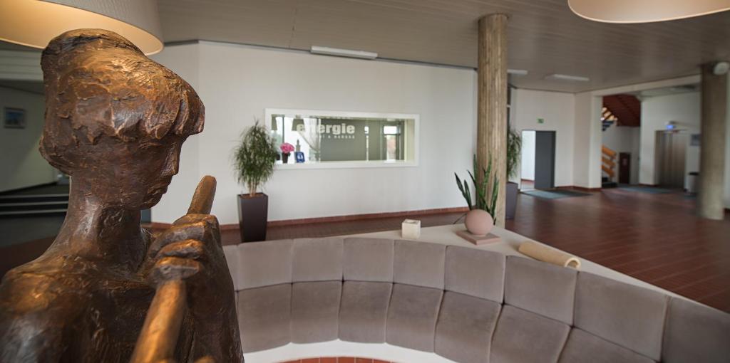 a statue of a person standing in a living room at Hotel Energie in Prague