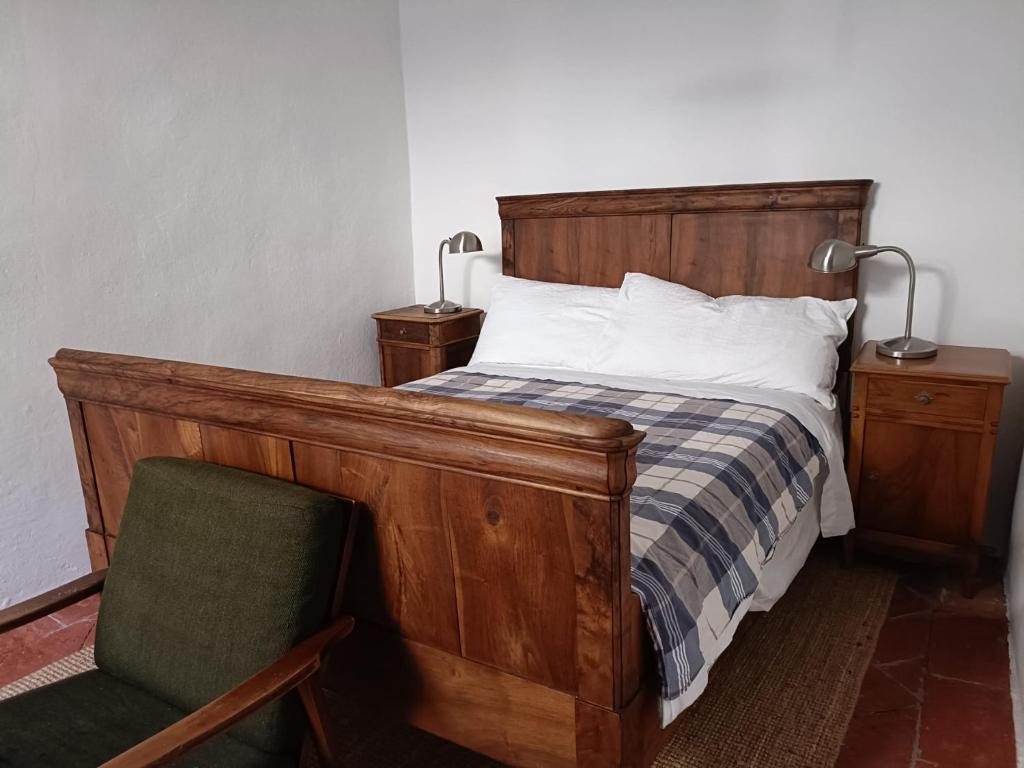 a bedroom with a bed and a chair and lamps at La Capinera in Muggio