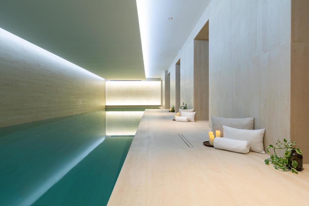 a hallway with a green and white room with pillows at Hôtel & SPA Napoléon in Fontainebleau