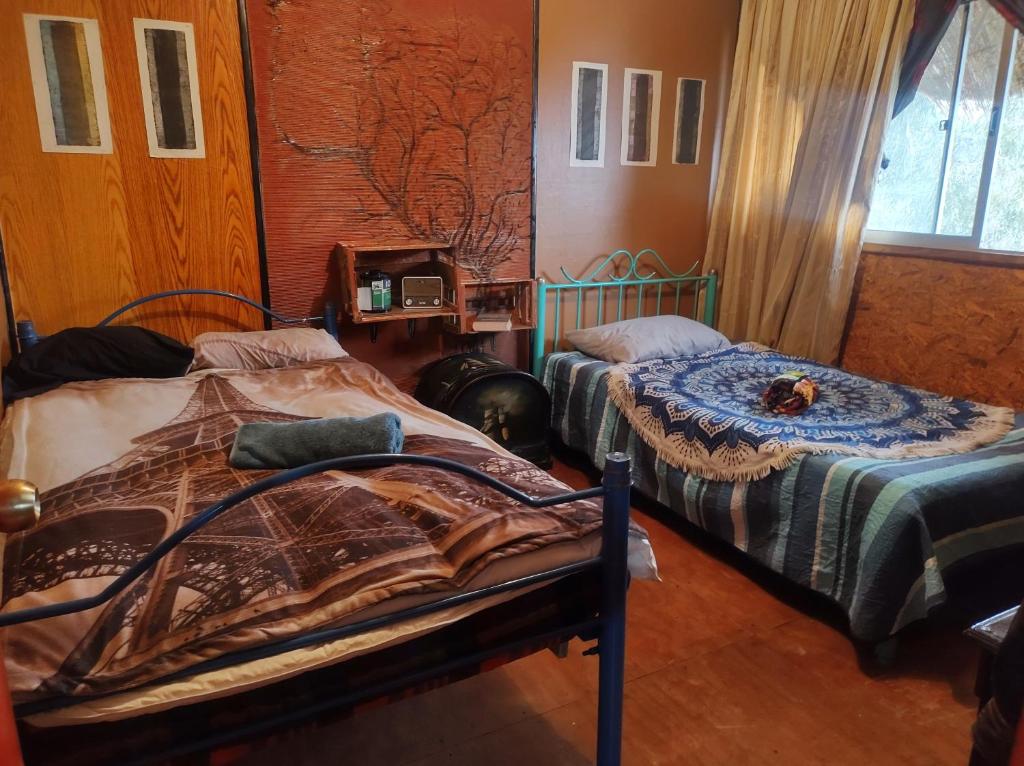 a bedroom with two beds in a room at Quiet cottage in a hill with great view not far to downtown in Santiago