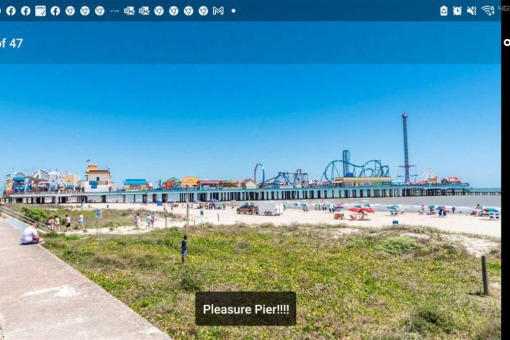 a view of a beach with a roller coaster at 18Th Street - Galveston Seawall Close to Attractions! Remodeled! in Galveston