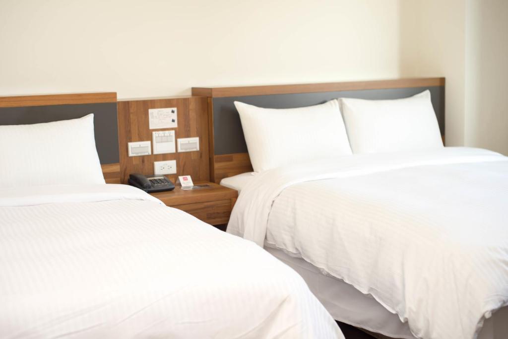 Postel nebo postele na pokoji v ubytování Bowa Hotel Penghu