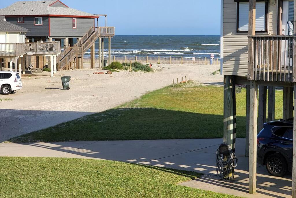 a house with a car parked next to a beach at Acapulco - Upstairs Beachview Beauty 50 steps to a private beach! BYOT in Galveston