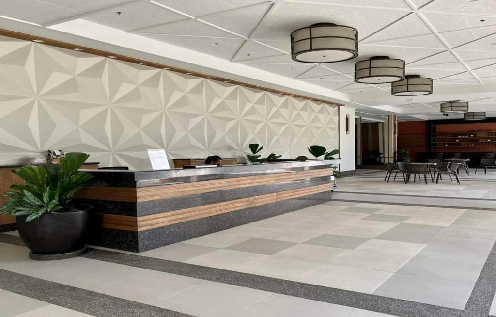 a lobby with a reception desk in a building at BGC-Ortigas Link Condo in Manila