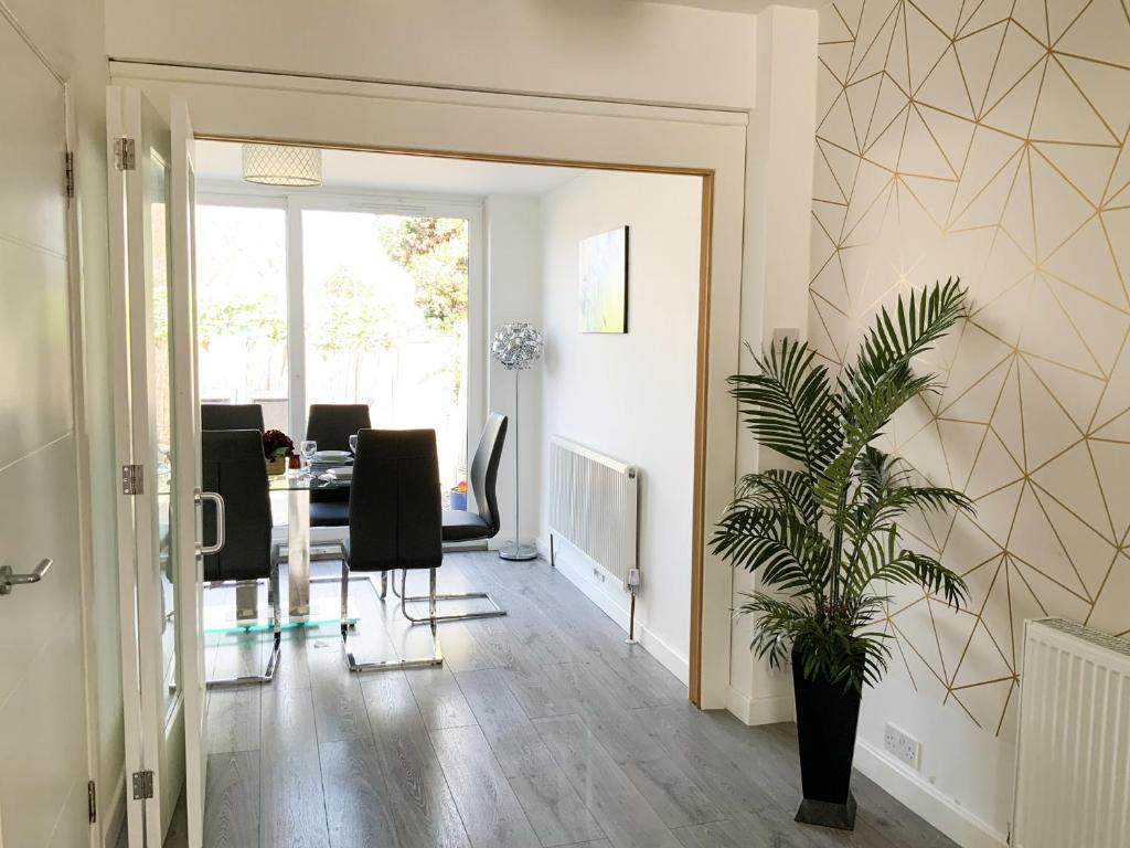 a hallway with chairs and a potted plant at De Montfort House in London