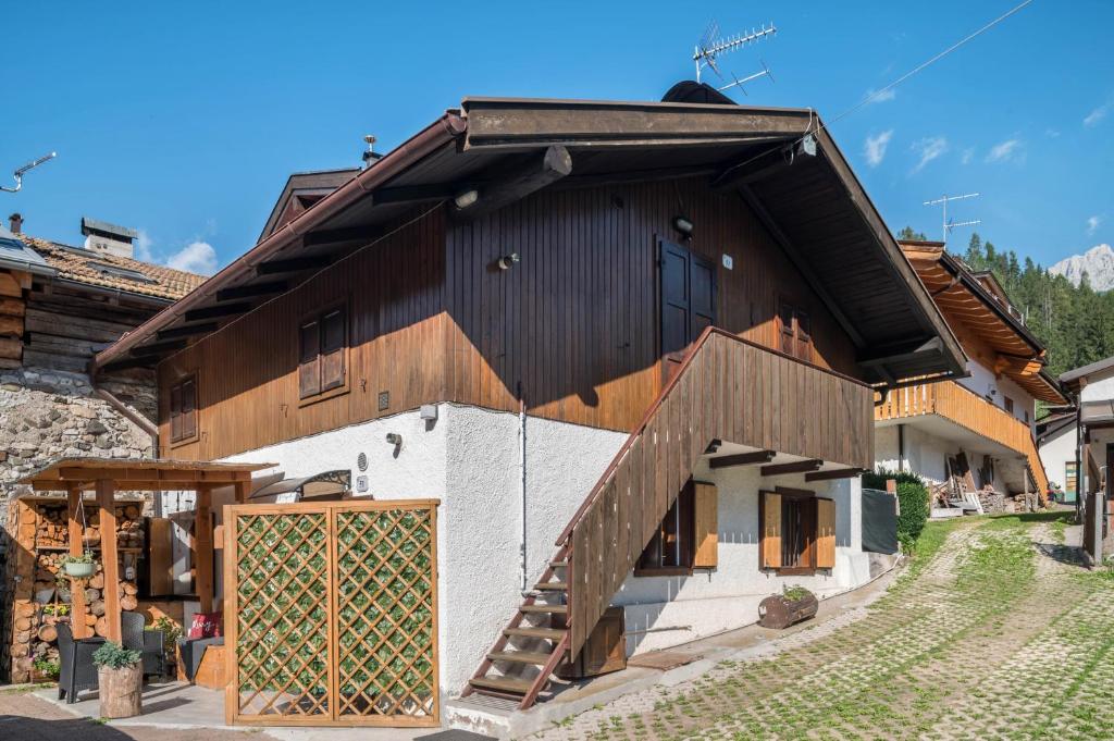 a large wooden building with a large door at Ciasa de Lucky in Moena