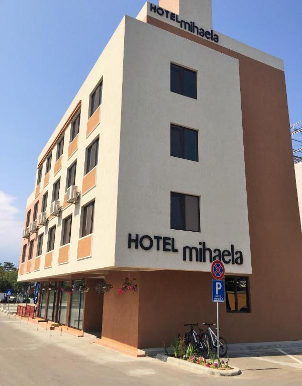 a hotel with a sign on the side of it at Hotel Mihaela in Mamaia