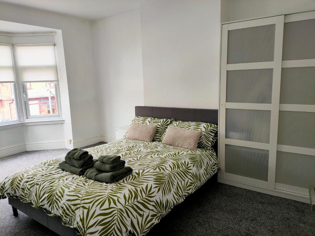 a bedroom with a bed with a zebra print sheets at Wentworth Road Accomodation in Doncaster