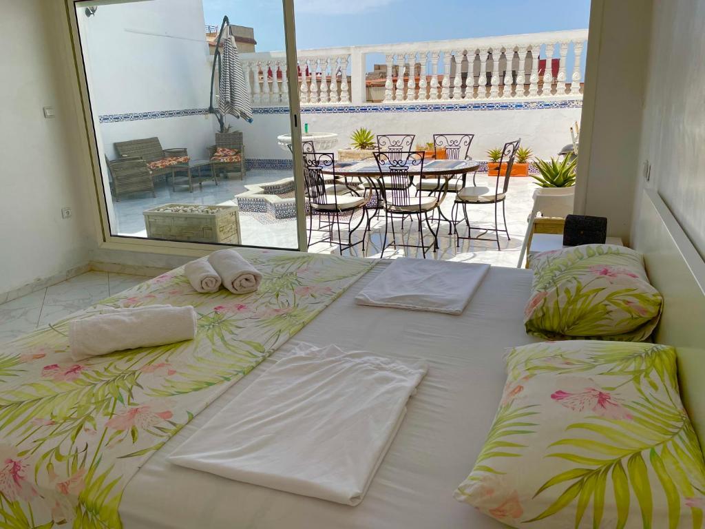 a large bed in a room with a view of a patio at Luxe appartement vc grand terrasse ( villa ) in Safi