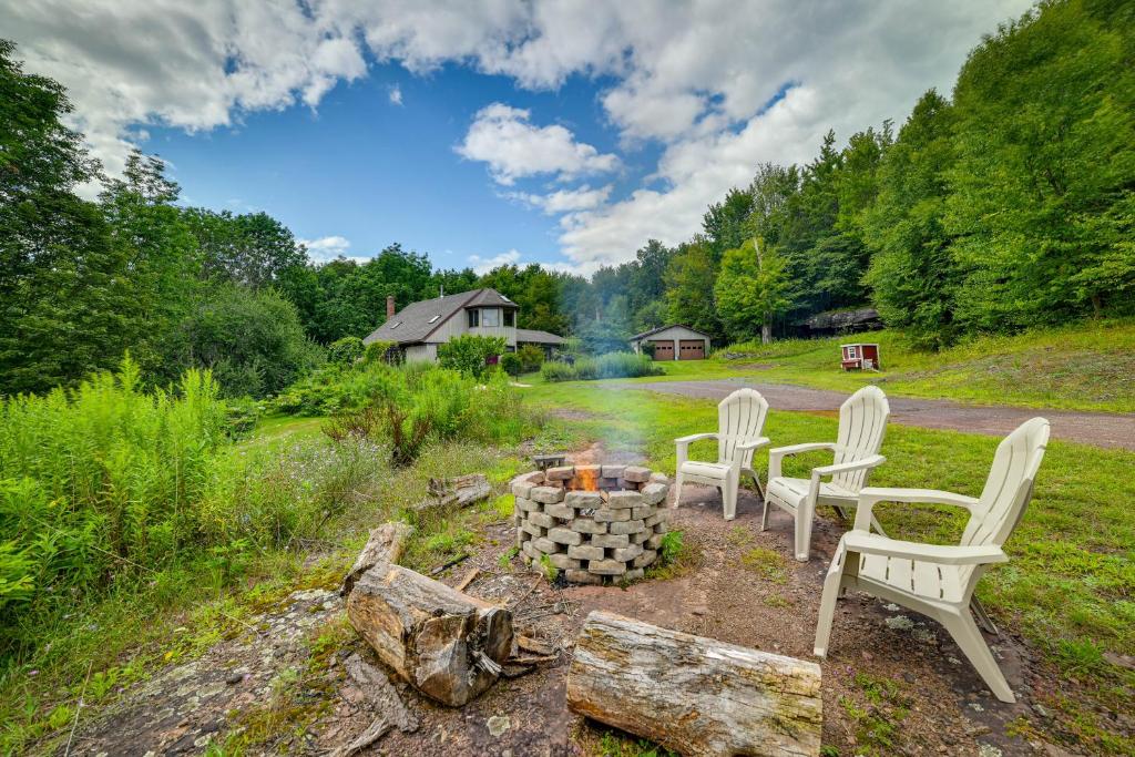 a group of chairs sitting around a fire pit at Catskills Mountain Cabin in Bloomville! in Stamford