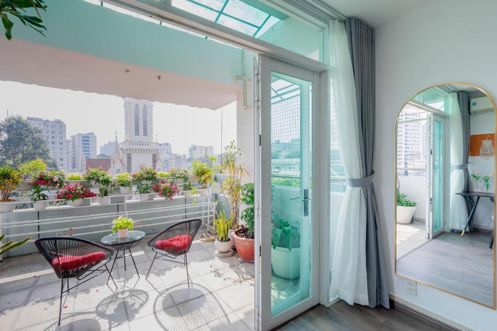 a balcony with chairs and a view of the city at SaziHome Ton That Tung Apartment in Ho Chi Minh City