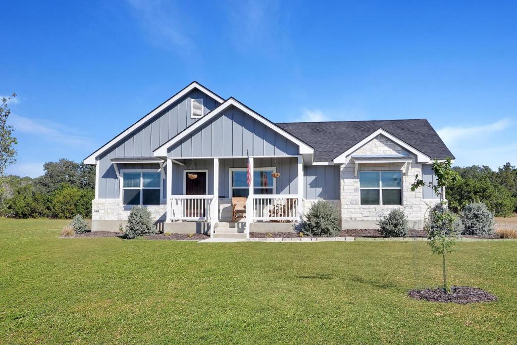 a large white house with a yard at Oasis by the Lake in Canyon Lake