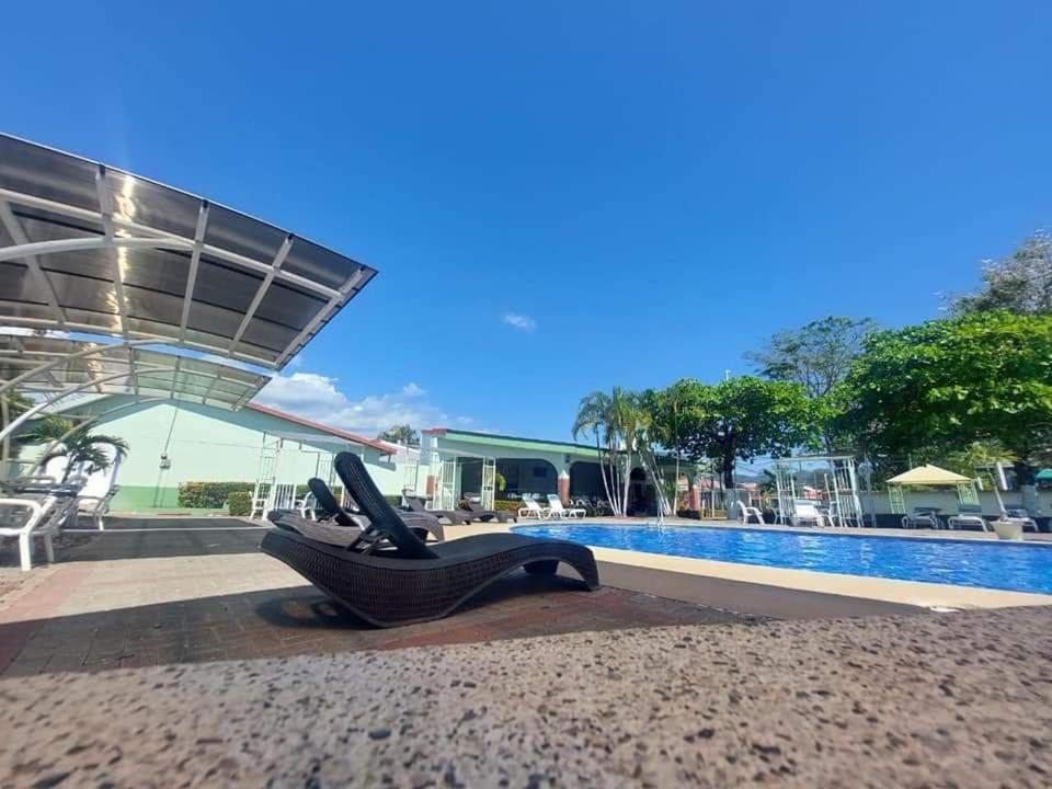 a sculpture of a reclining chair next to a pool at Casa Yorba in Jacó