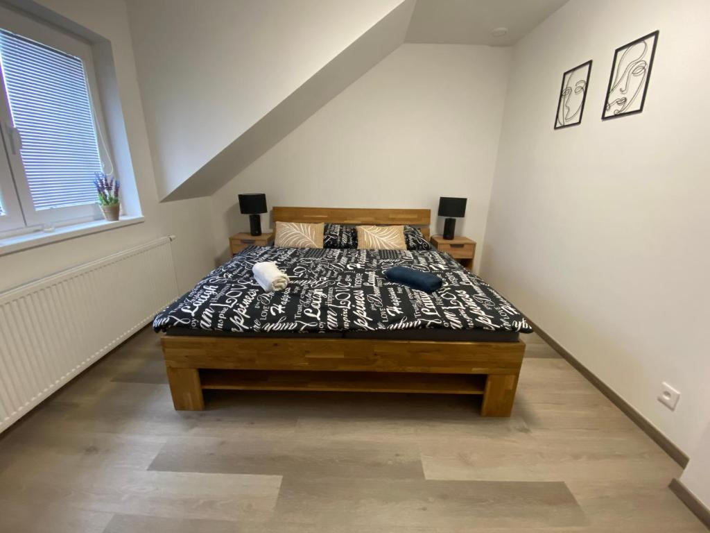 a bedroom with a bed in a room at Černá růže - Apartmán 6 in Pilsen