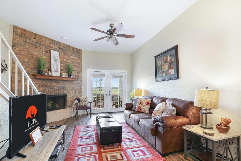 a living room with a couch and a fireplace at Cozy Glimmer in Canyon Lake