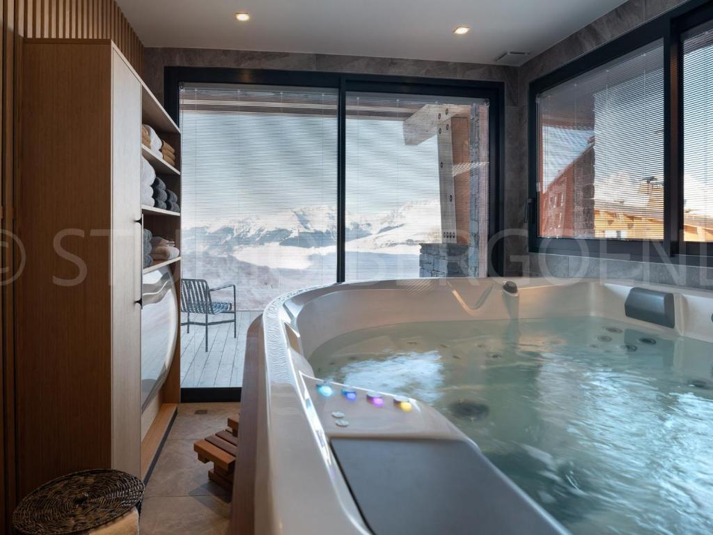 a bath tub with a view of a mountain at Chalet Les Arcs 1800, 8 pièces, 14 personnes - FR-1-686-29 in Arc 1800
