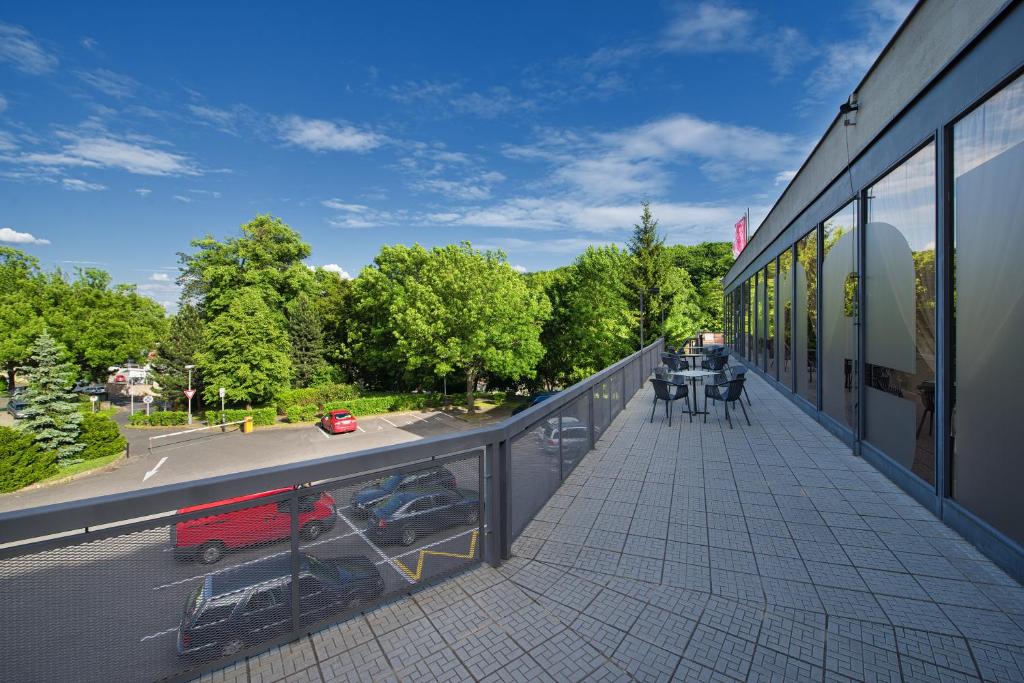 a balcony of a building with a view of a street at Hotel Energie in Prague