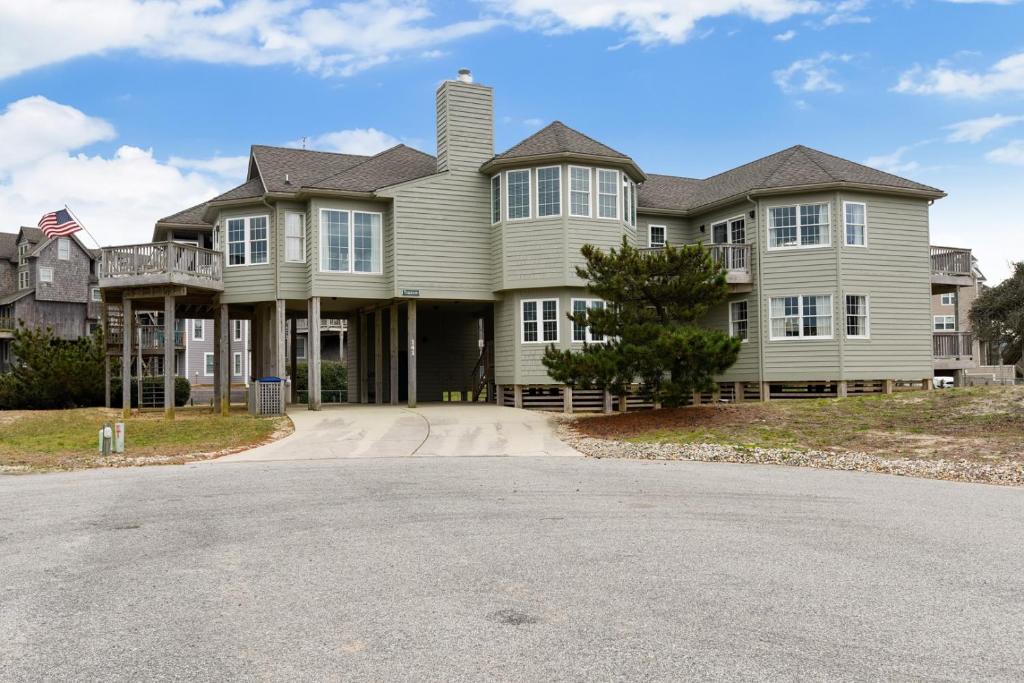 a large house with a road in front of it at The Tappan at Ships Watch in Duck