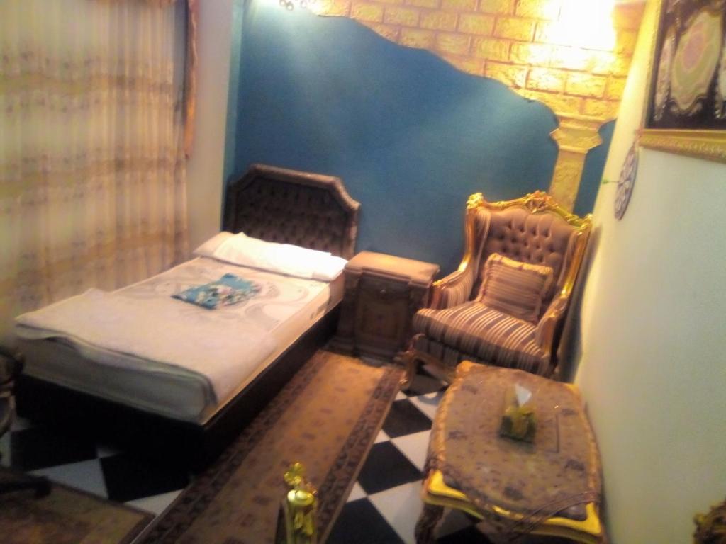 a small bedroom with a bed and a chair at غرفة خاصة الاسكندريه Sidi Bishr in Alexandria