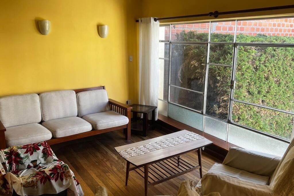 a living room with a couch and a large window at Don Julio’s House in La Paz