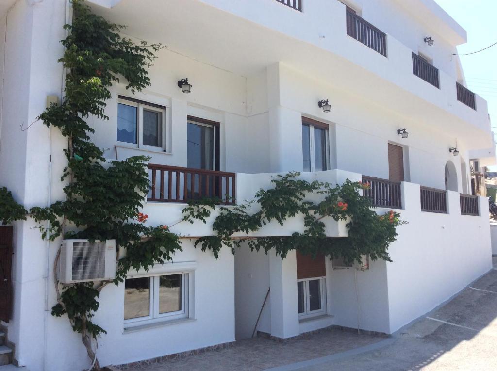 a white building with a balcony at Filippos in Adamantas