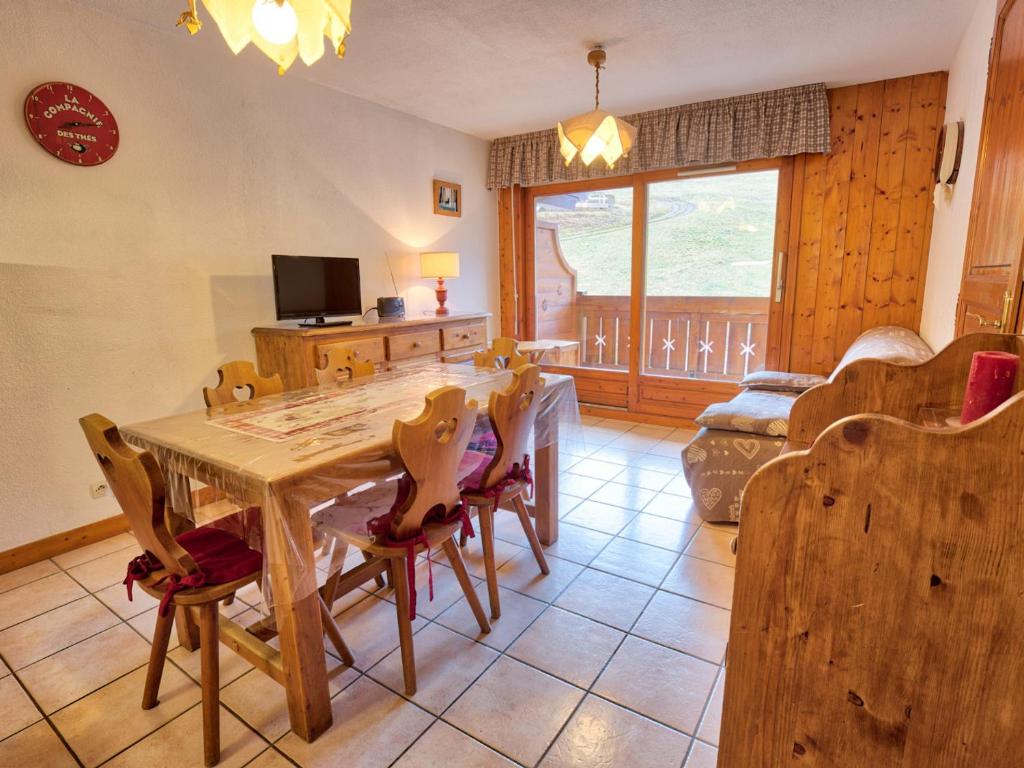 a dining room with a wooden table and chairs at Appartement Flumet, 2 pièces, 6 personnes - FR-1-505-20 in Flumet