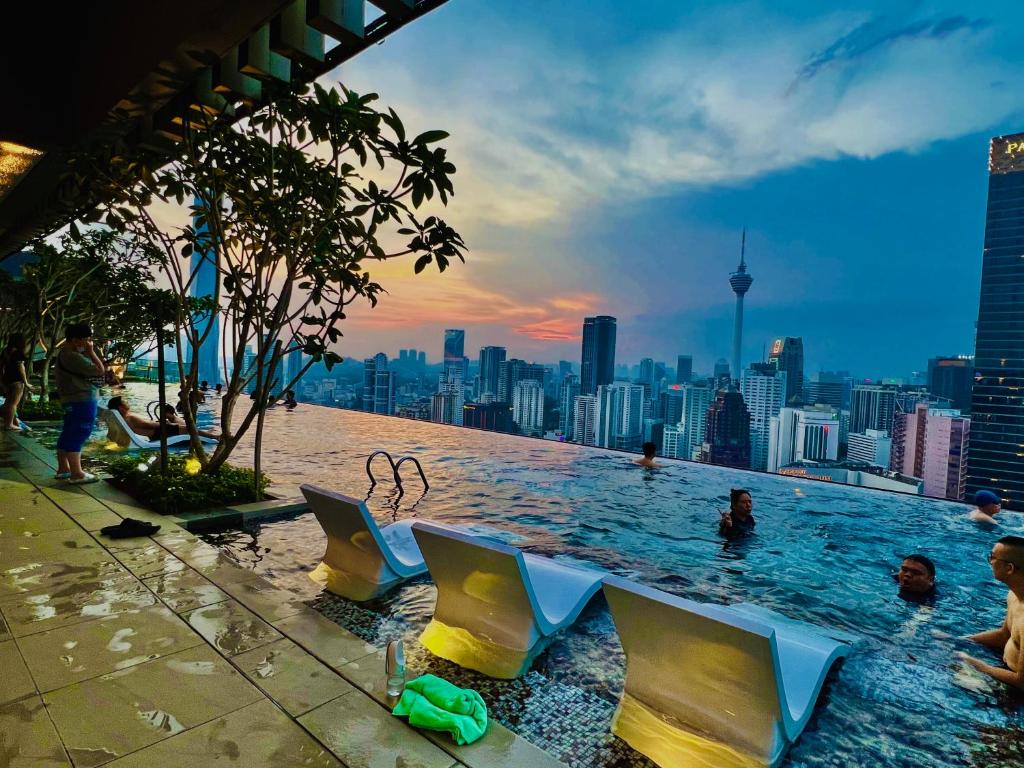 a swimming pool with a view of a city at The Axon Suites Bukit Bintang By Cozy Stay in Kuala Lumpur