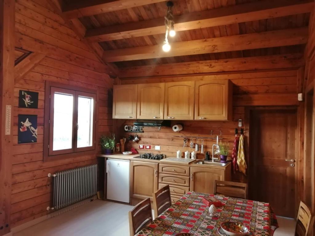 una cocina con paredes de madera y una mesa en una habitación en HenFeverSicily Chalet Colapesce en Casa Modica