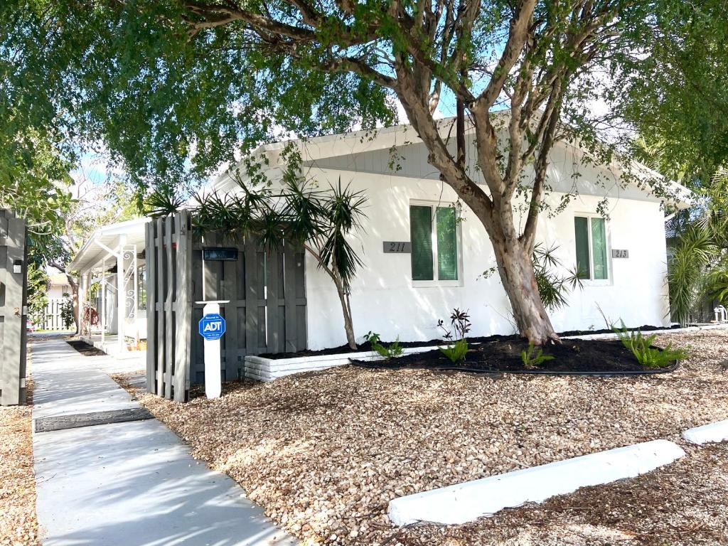 a white house with a tree in front of it at Tropical 2-Bedroom 1-Bath Private Key West-like Home Close To Beach in Pompano Beach