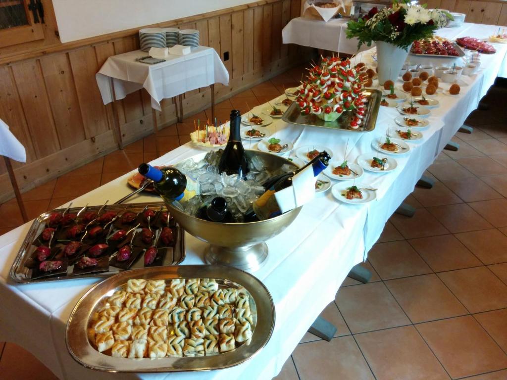 a long table with a buffet of food and drinks at Hotel Terminus in Samedan