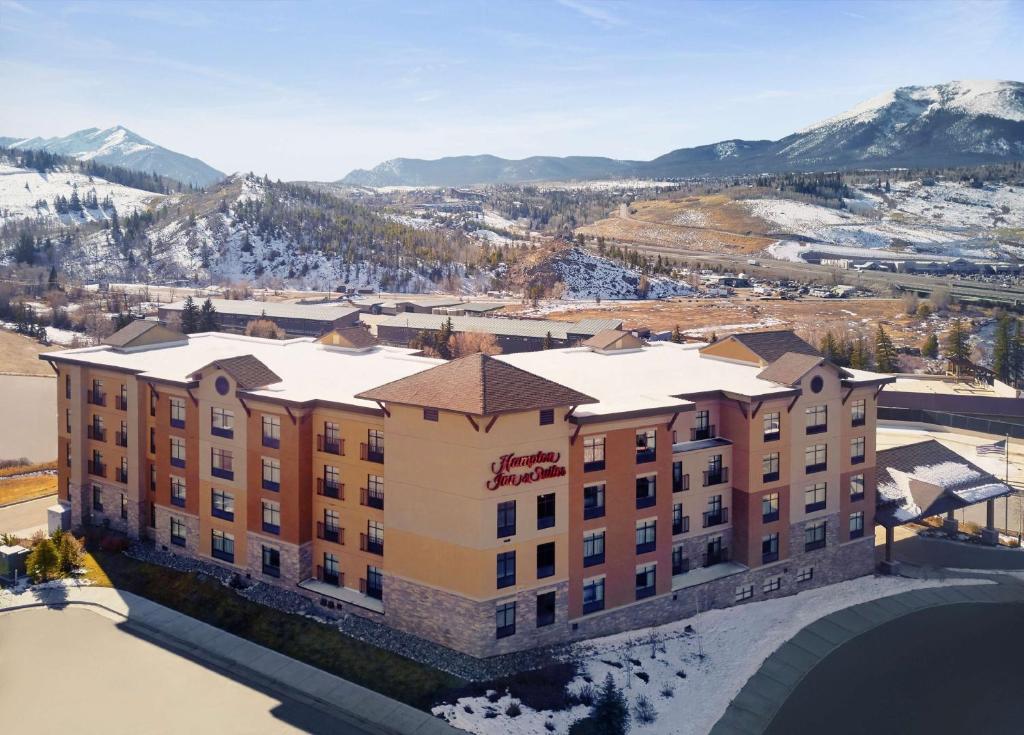 an aerial view of a hotel with snow covered mountains at Hampton Inn & Suites Silverthorne in Silverthorne