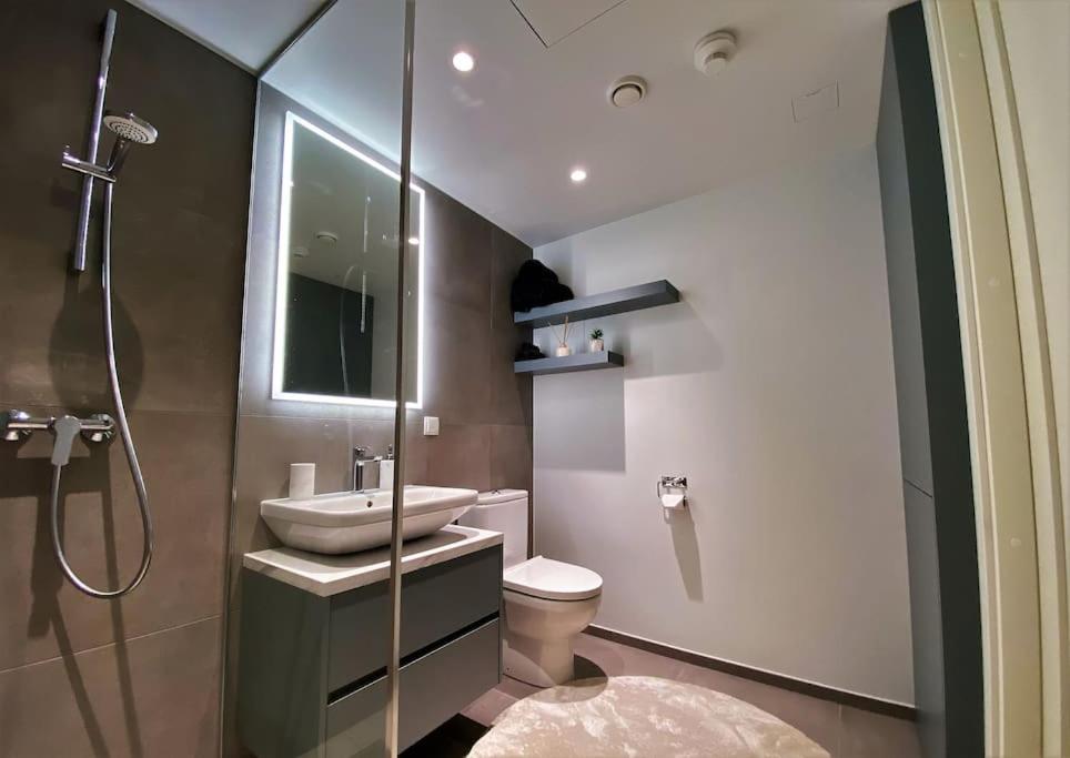 La salle de bains est pourvue de toilettes, d'un lavabo et d'une douche. dans l'établissement Penthouse apartment with an amazing view, à Tallinn