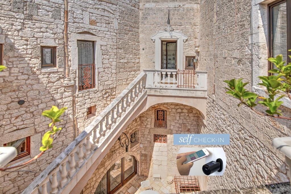 an external view of a building with stairs and a camera at Dimora Dell'Osanna in Carovigno