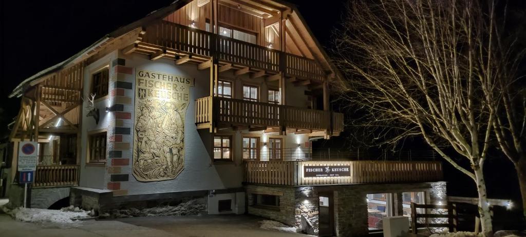 a building with a sign on the side of it at Burglodge Fischerkeusche in Mauterndorf
