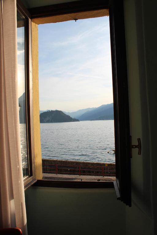 a window with a view of the water at Namaste apartment Fiumelatte-lake view in Varenna