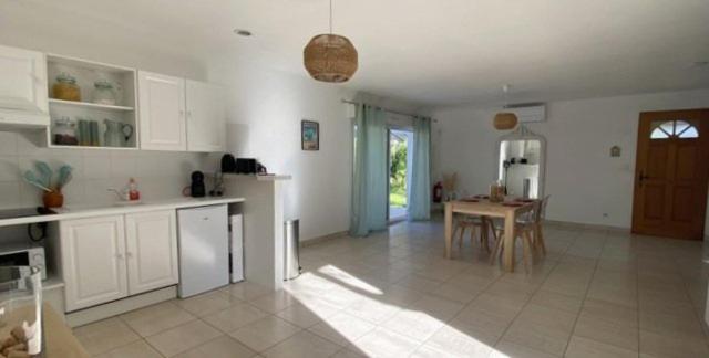 a kitchen with white cabinets and a table in it at Mas des catalanes dépendance privé climatisation, wifi 2MASCAT39 in Perpignan