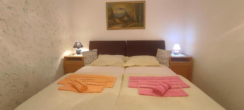 a bedroom with a bed with two towels on it at Apartman Safir in Sarajevo