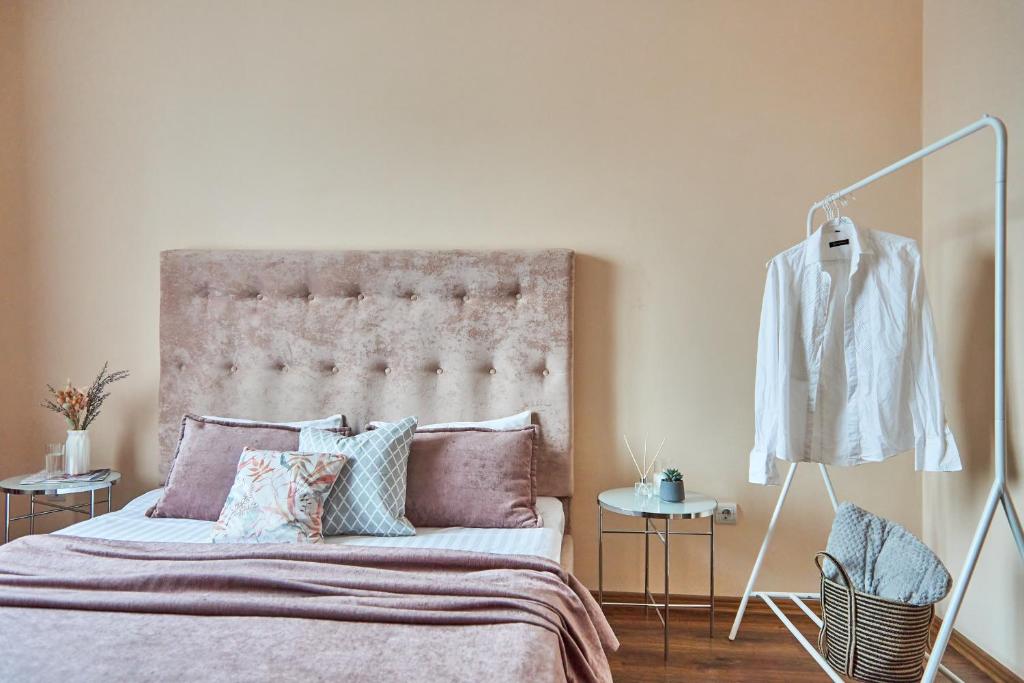 a bedroom with a bed with a large headboard at Central Two room Lux Apartments in Mukacheve