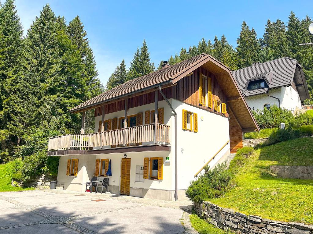 a house with a balcony on the side of it at Chalet Harmony Rogla - apartment in Zreče