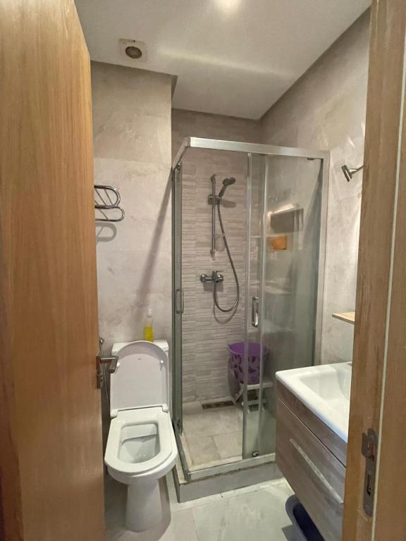 a bathroom with a shower and a toilet and a sink at relax à Costa Beach in Bouznika