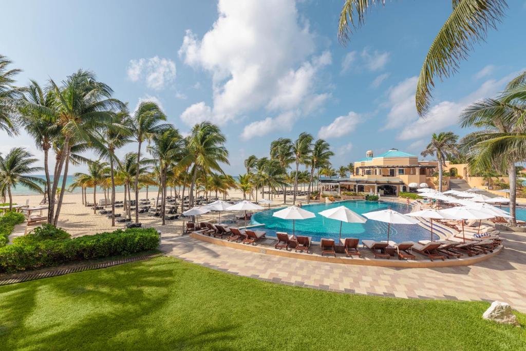 an image of a resort with a pool and palm trees at Royal Hideaway Playacar All-Inclusive Adults Only Resort in Playa del Carmen