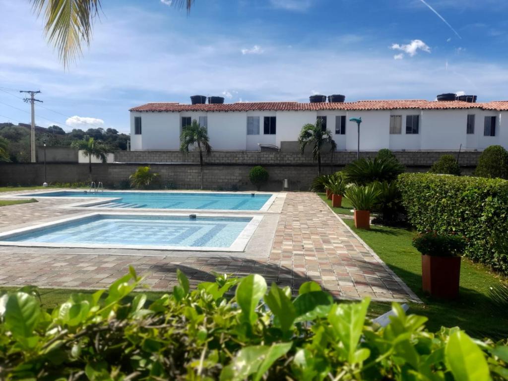 a villa with a swimming pool and a house at CASA AMOBLADA EN CONJUNTO CERRADO in Cúcuta